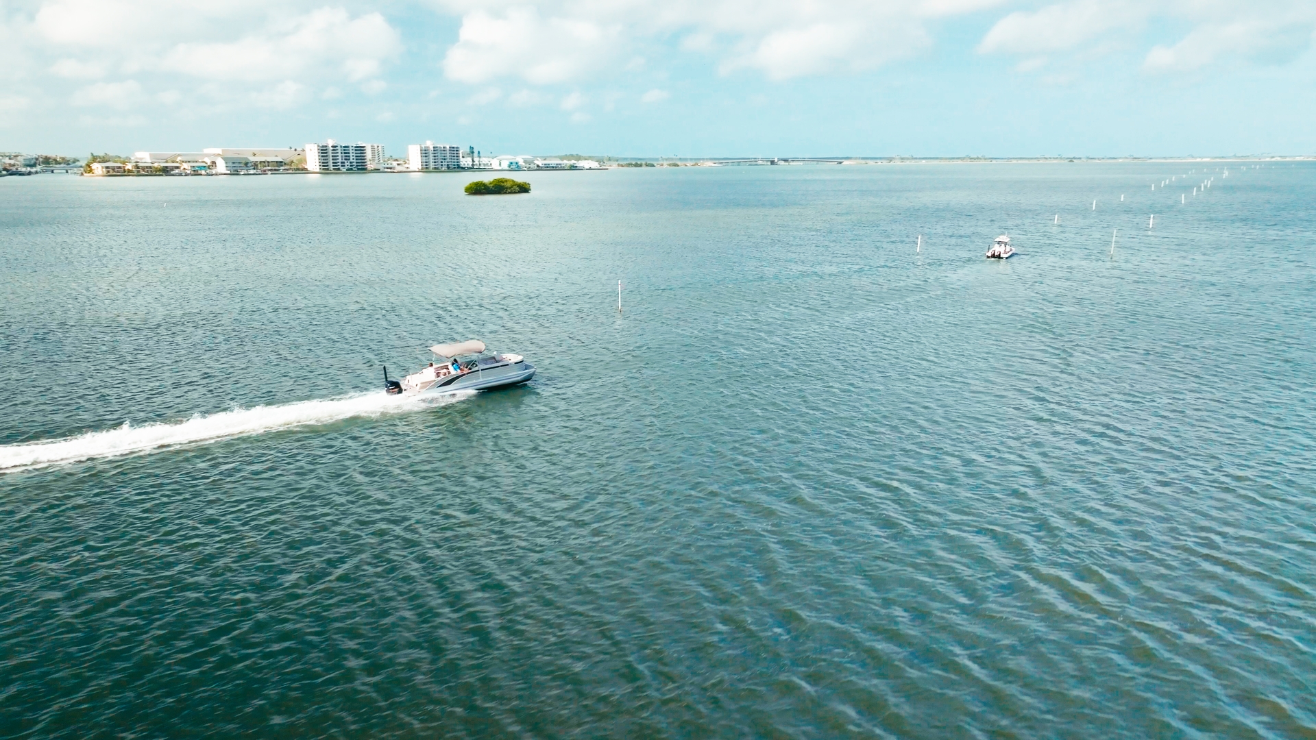 Aerial view of a Marker 26 pontoon boat cruising on Tampa Bay near Palm Harbor, FL